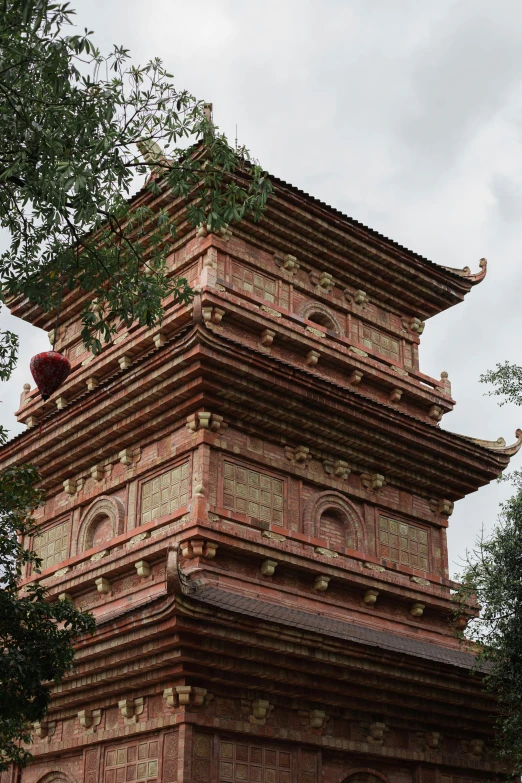 an old red and brown building with chinese writing