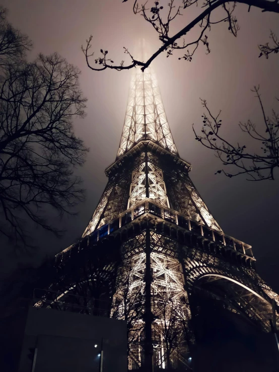 the view from below of a tall tower at night