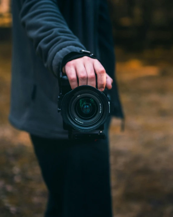 a man holds an open camera to take pos