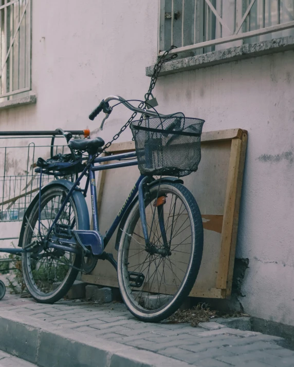 bicycle leaning against a wall in front of some buildings