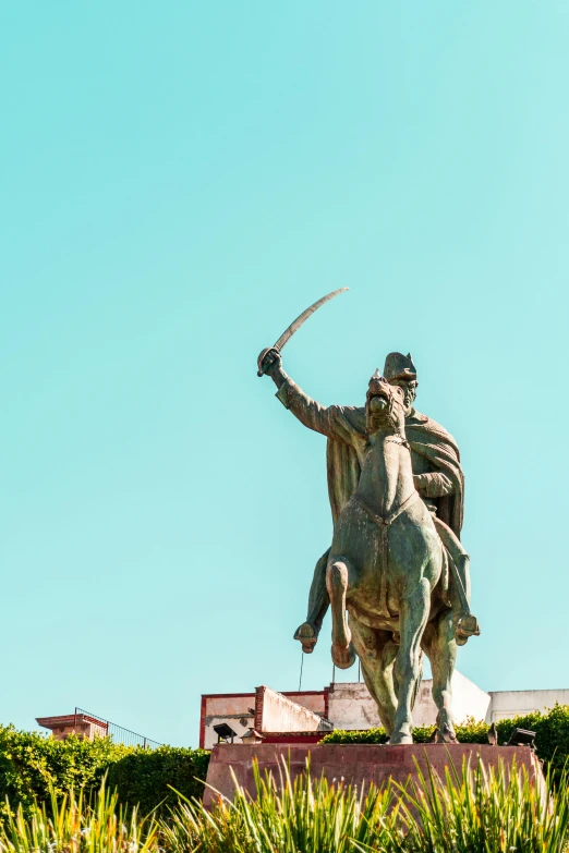 a statue of a man sitting on a horse with a spear