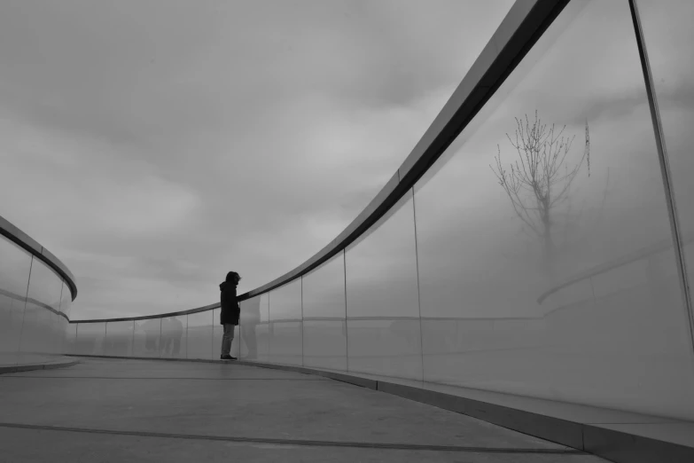 an individual standing near an unusual structure in the distance