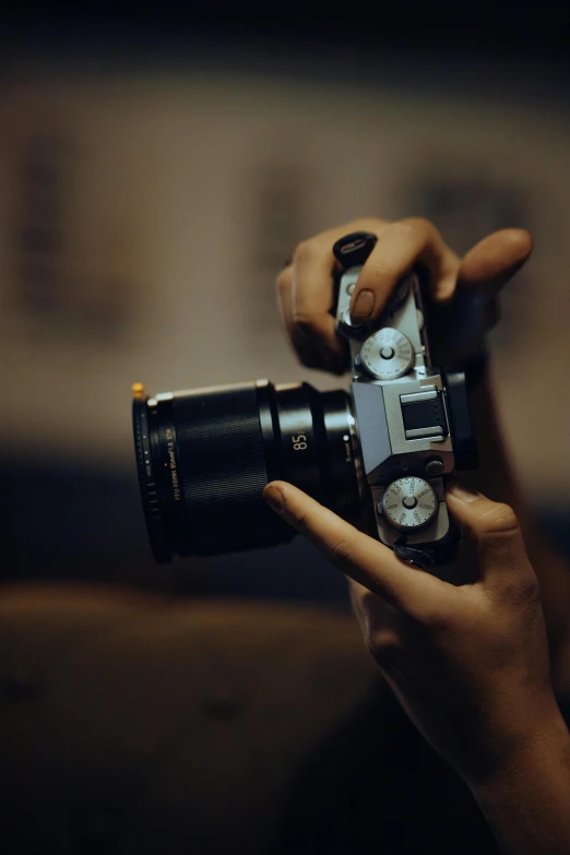 a person takes a pograph of another person holding a camera