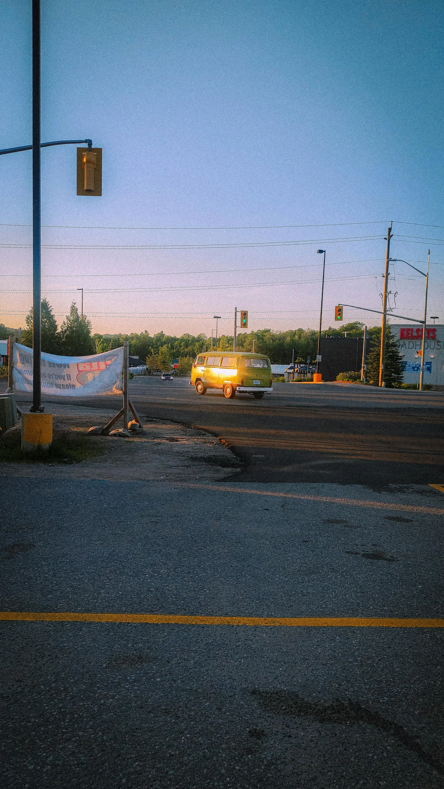 a small road with a traffic light in the middle