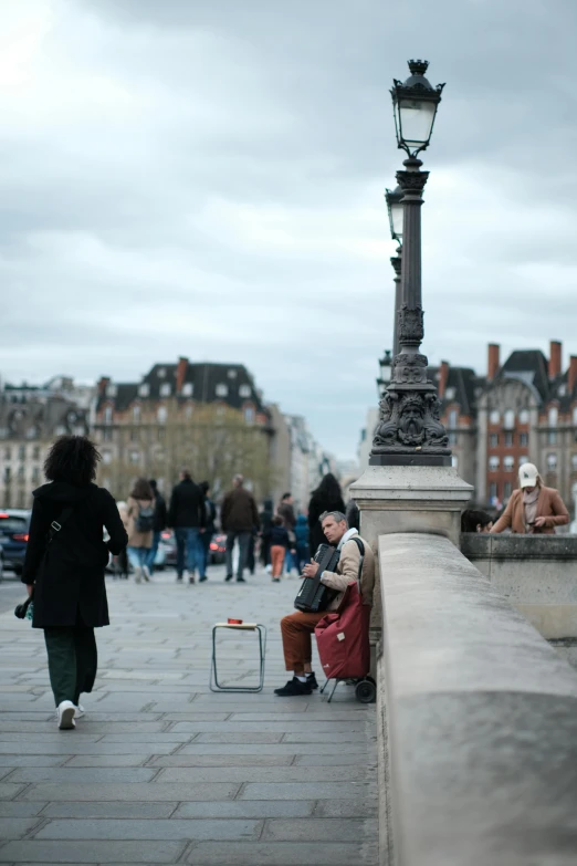 a couple of people that are sitting on a walkway