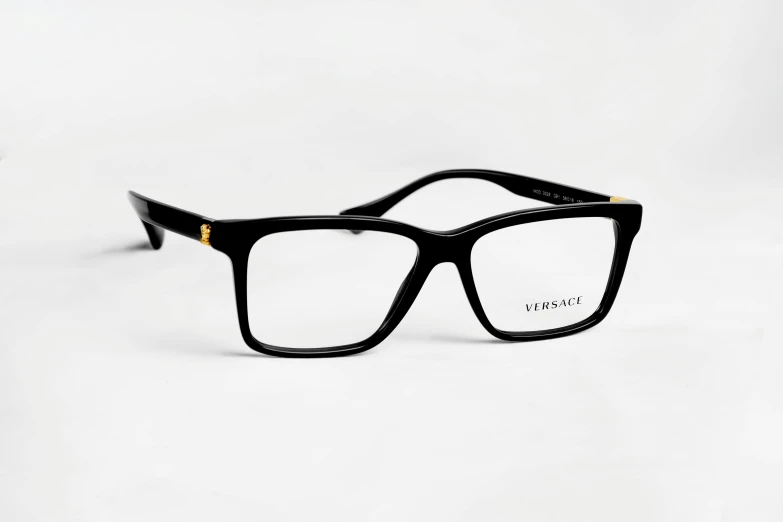 a pair of glasses sitting on top of a white surface