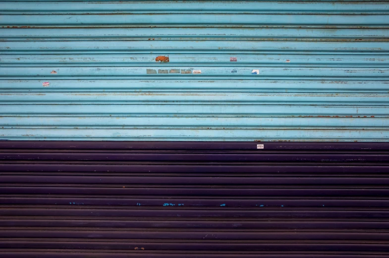 an open blue garage door with a white and black train track