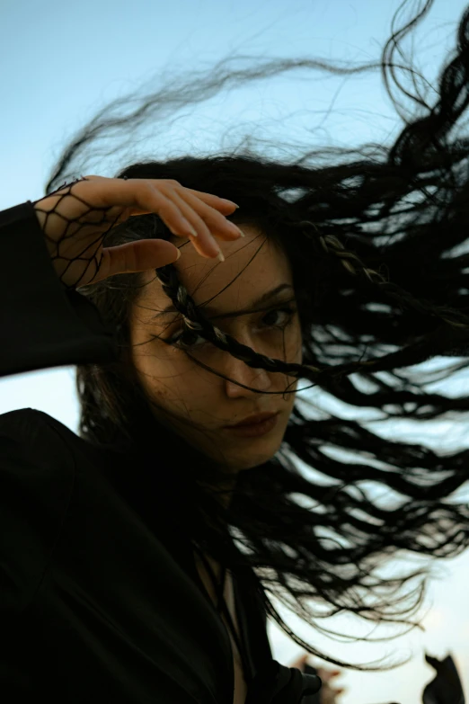 a woman with hair flying in the air