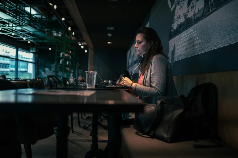 woman sitting down on the phone in a restaurant