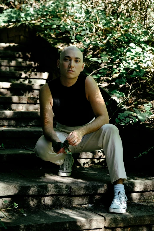 a man sits on some steps with a drink