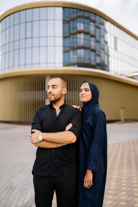 a couple stands near each other outside of a building