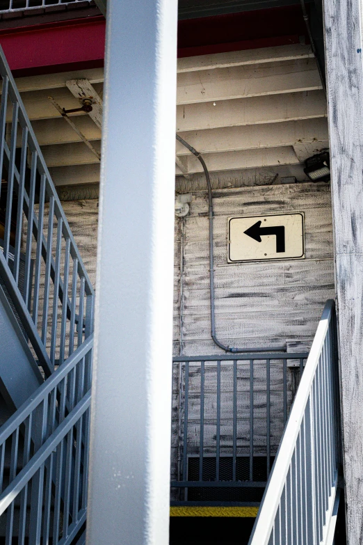 two large columns next to stairs leading up to an open exit way