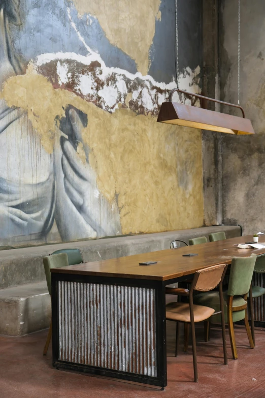 an empty restaurant with a large painting of jesus behind the tables