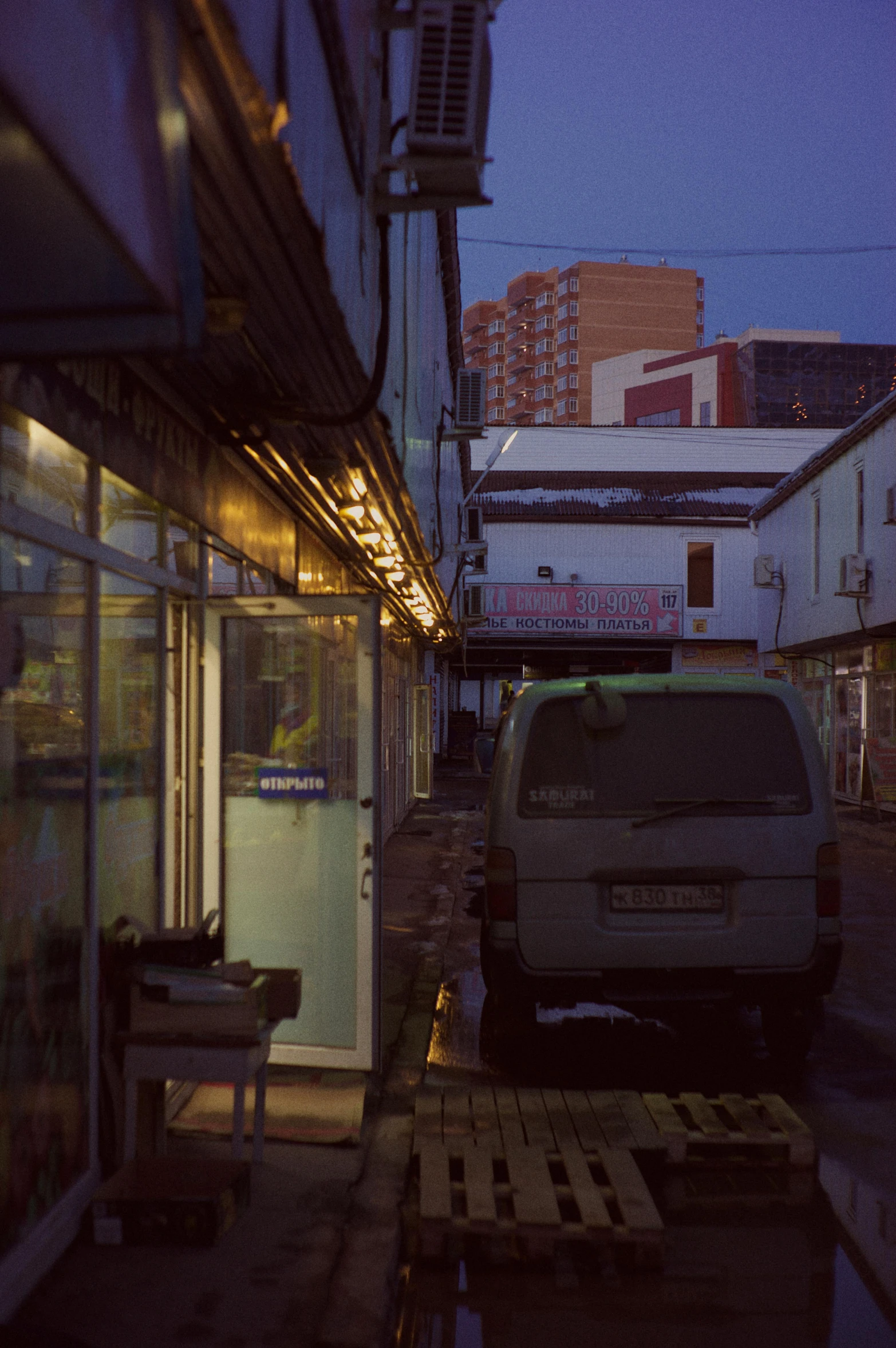 a mini van parked next to a building at night