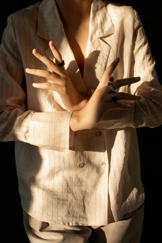 a woman's hand is extended and smoking a cigarette