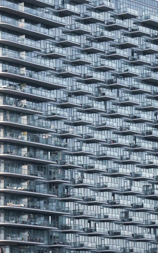 a large glass and steel building against a blue sky