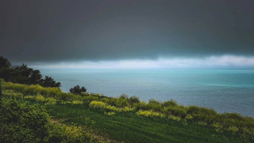 a scenic view of the ocean in a dark and stormy day