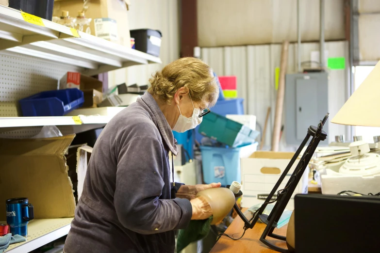 a person working in a craft room with lots of craft supplies