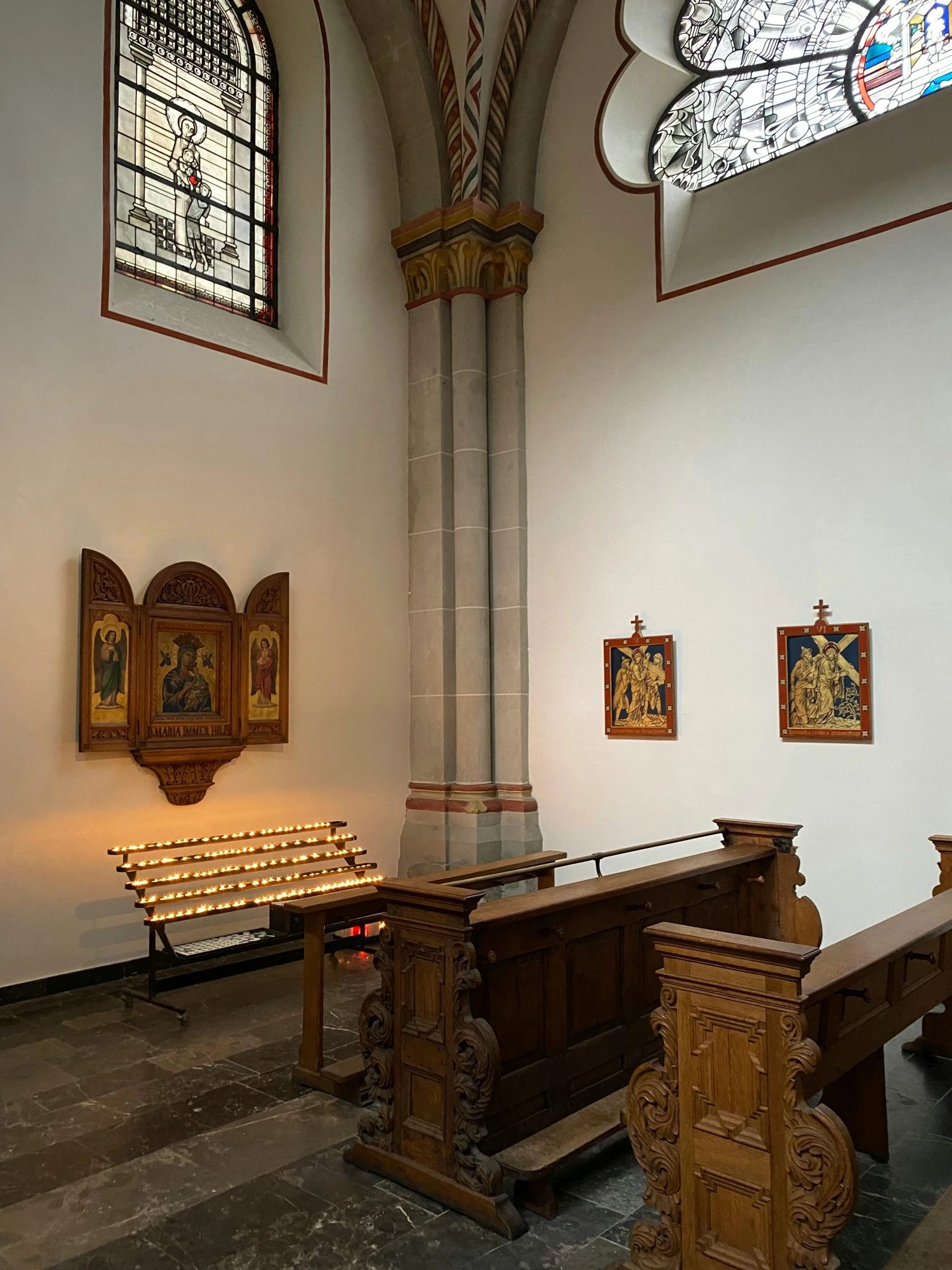 wooden benches inside of a church with stained glass windows