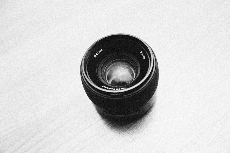 a camera lens with its hood in close up