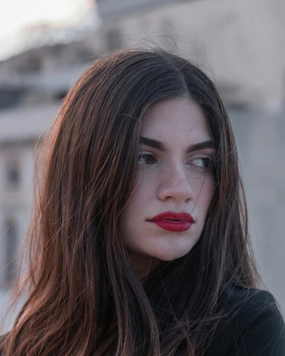 a woman with long hair and red lipstick