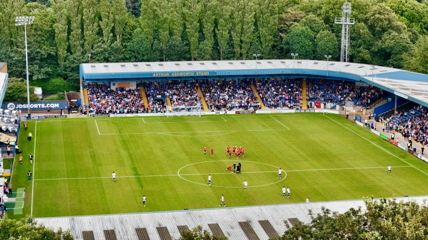 a soccer game in progress in a stadium with fans