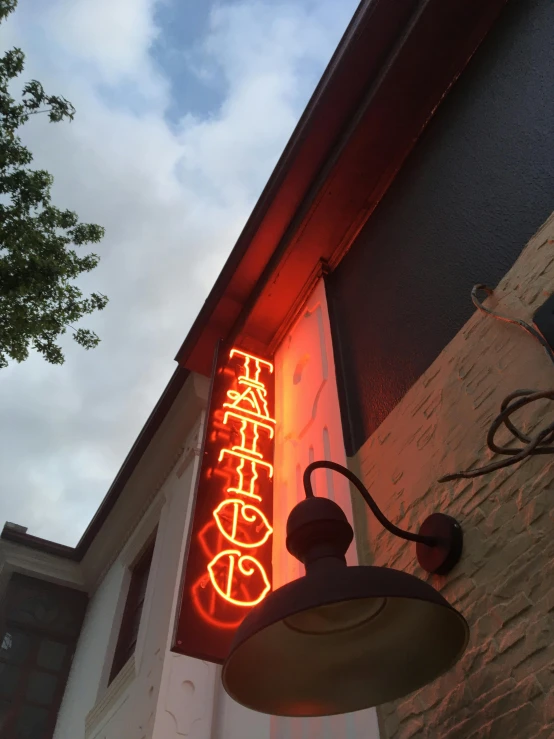 a building with a neon sign for a chinese restaurant