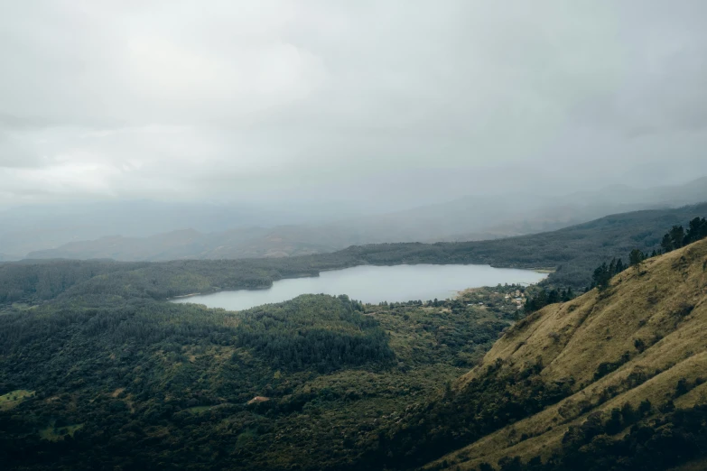 a lake sitting on top of a lush green hillside