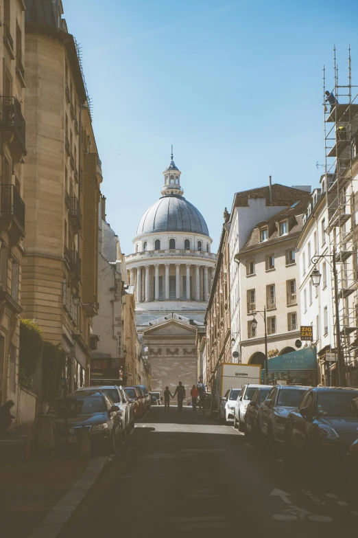 a wide view of an old city with people and cars