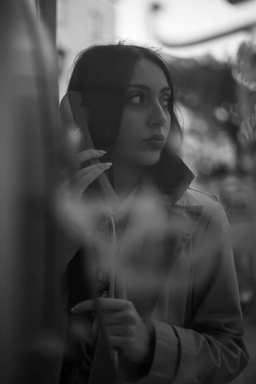 a girl holding a cell phone up to her ear