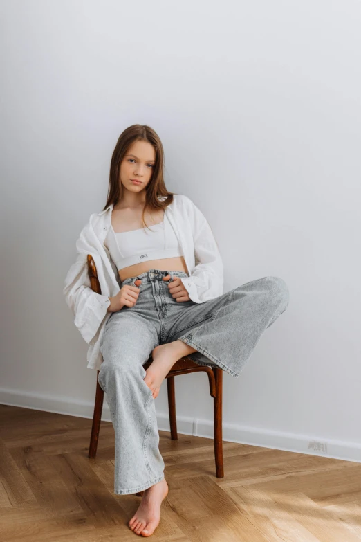 a woman sitting in a chair and posing for the camera