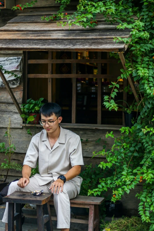 a man is sitting at a small table