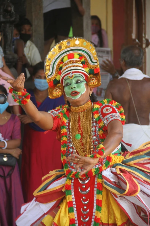 a man dressed up in colorful costumes and makeup