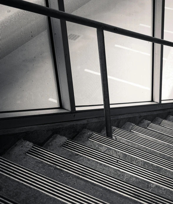 black and white po of stairs and railings in a room