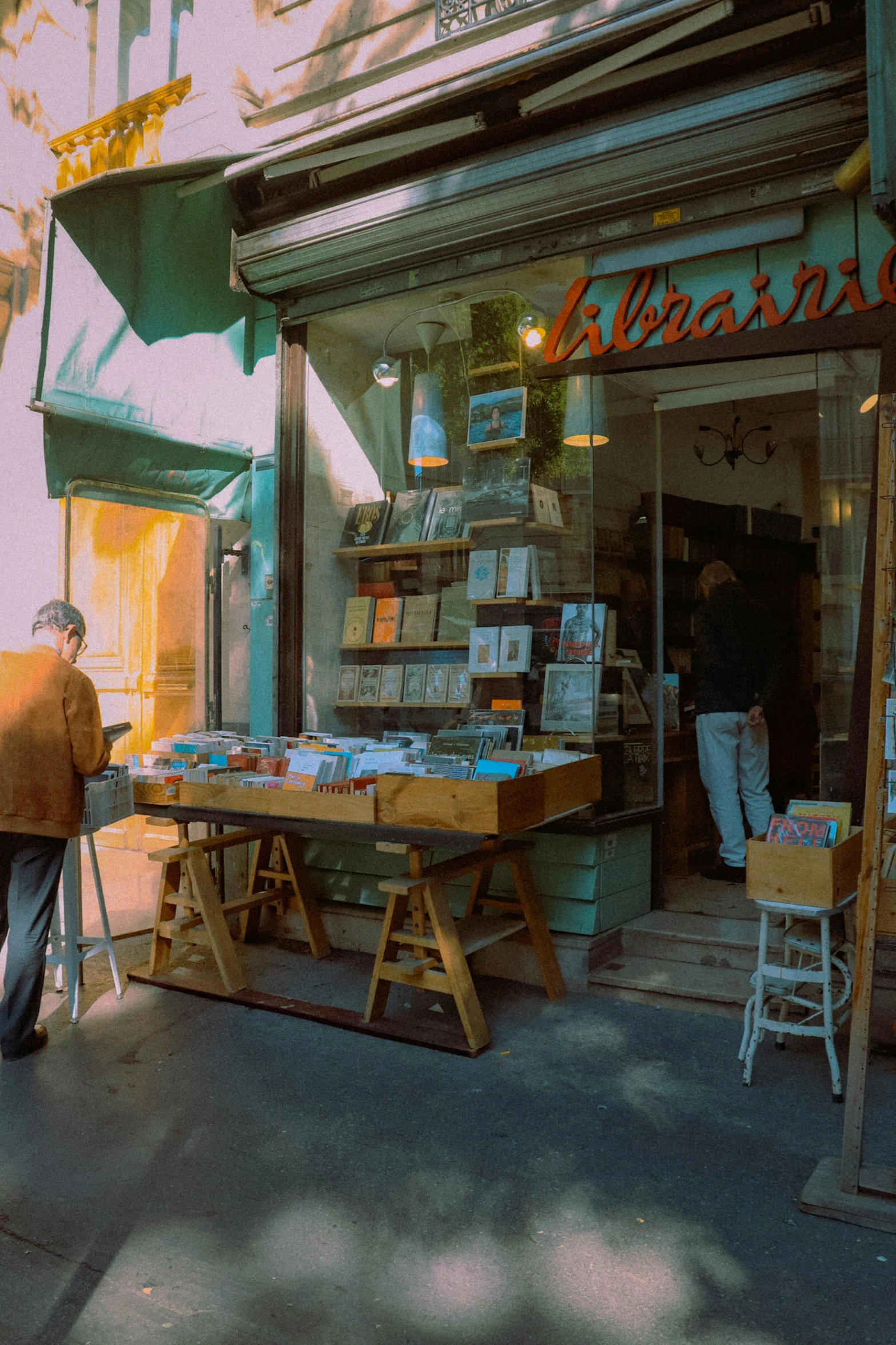 a man walking in front of a store on the street