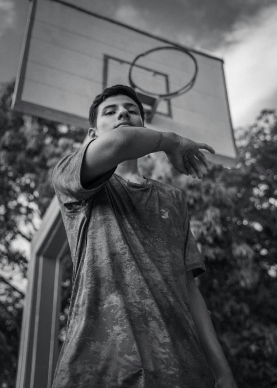 a man holding a basketball over a basketball hoop