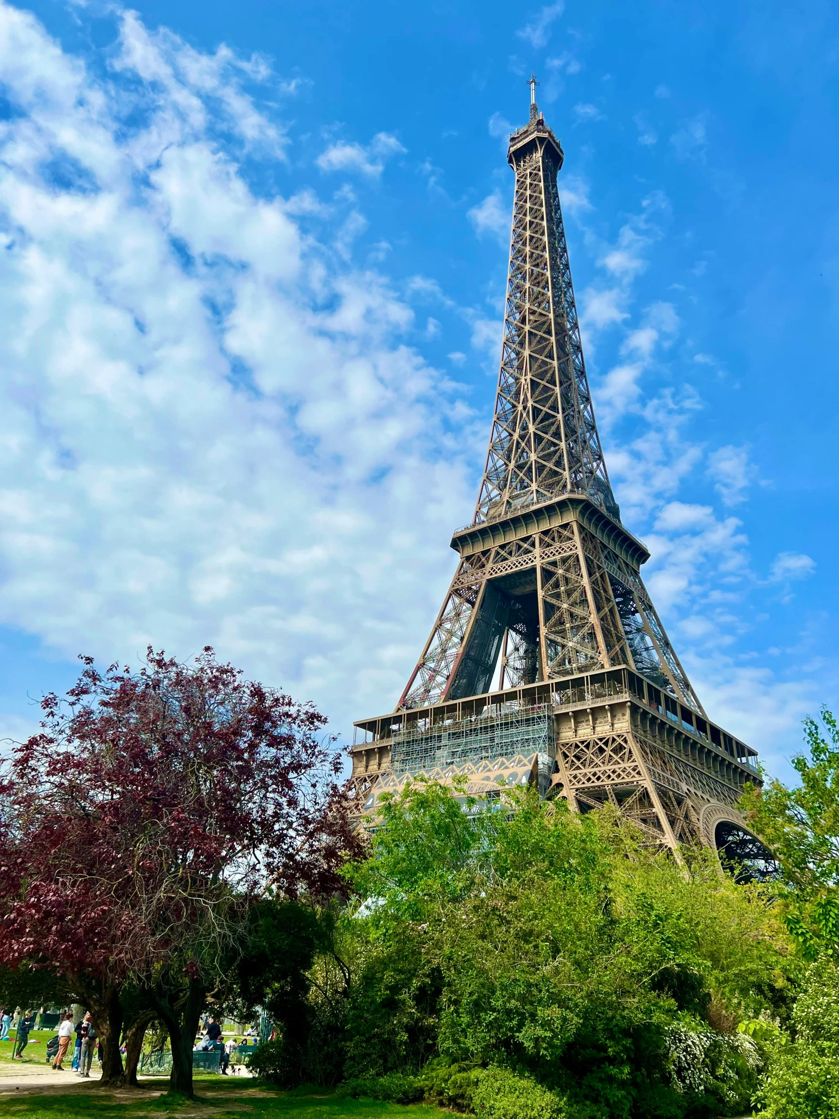 the eiffel tower is very tall with a clock displayed on it