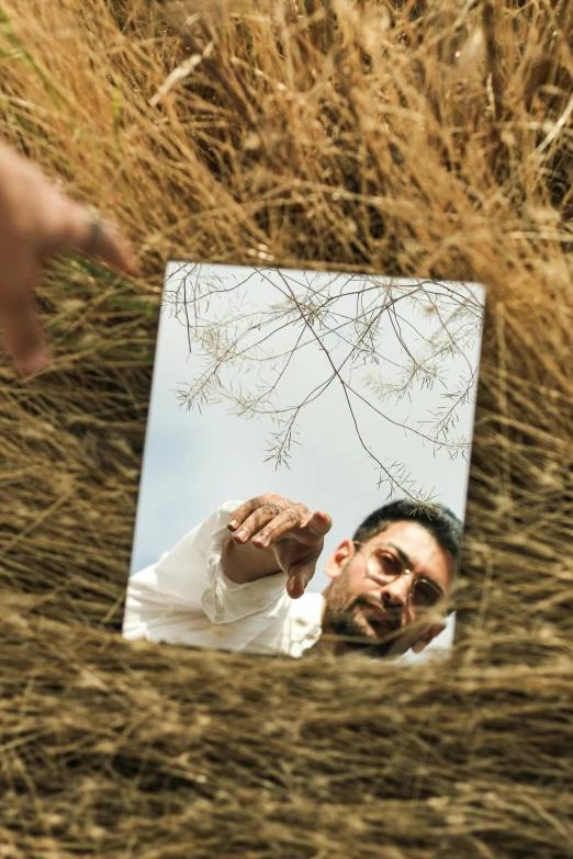 a person with a knife is taking a selfie in front of a mirror