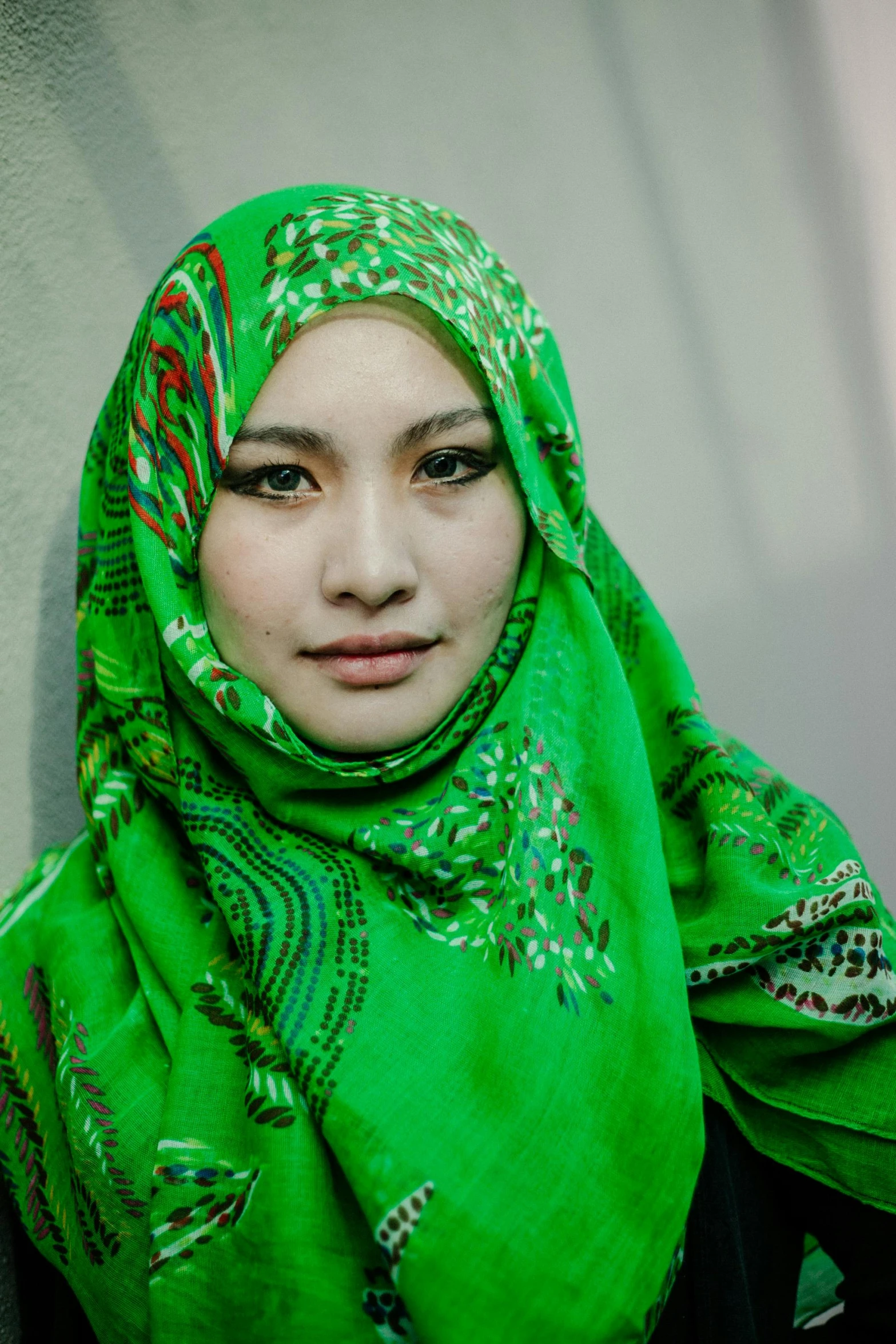 a girl is in bright green scarf and headgear