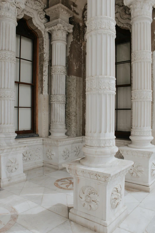 columns and windows in a room with white walls