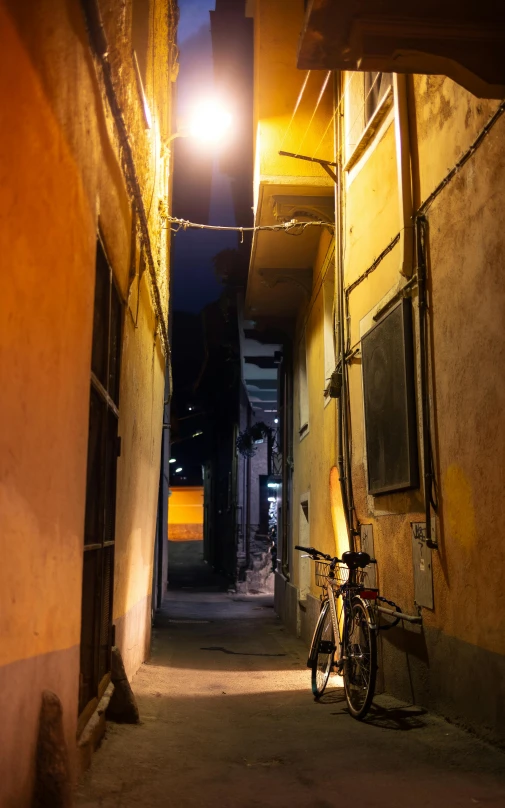 a bicycle leaning against a wall with the back light on