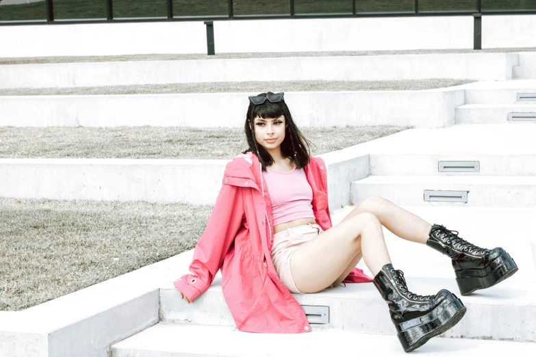 a beautiful woman posing on the steps of some stairs