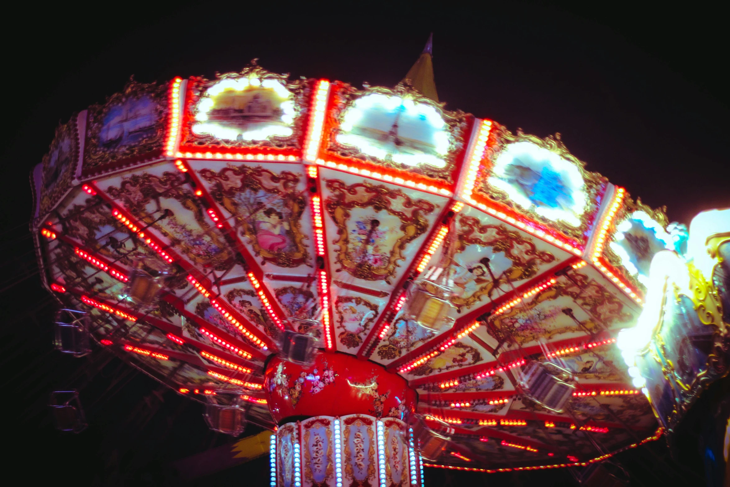 a brightly lit carnival ride at night time