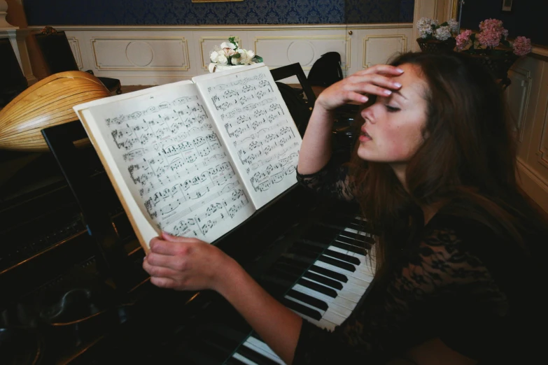 a woman is holding up an open book