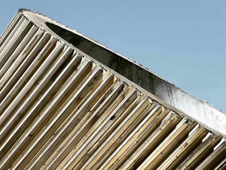 the curved section of a building against a blue sky