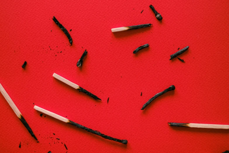 a pile of matches placed together with red background