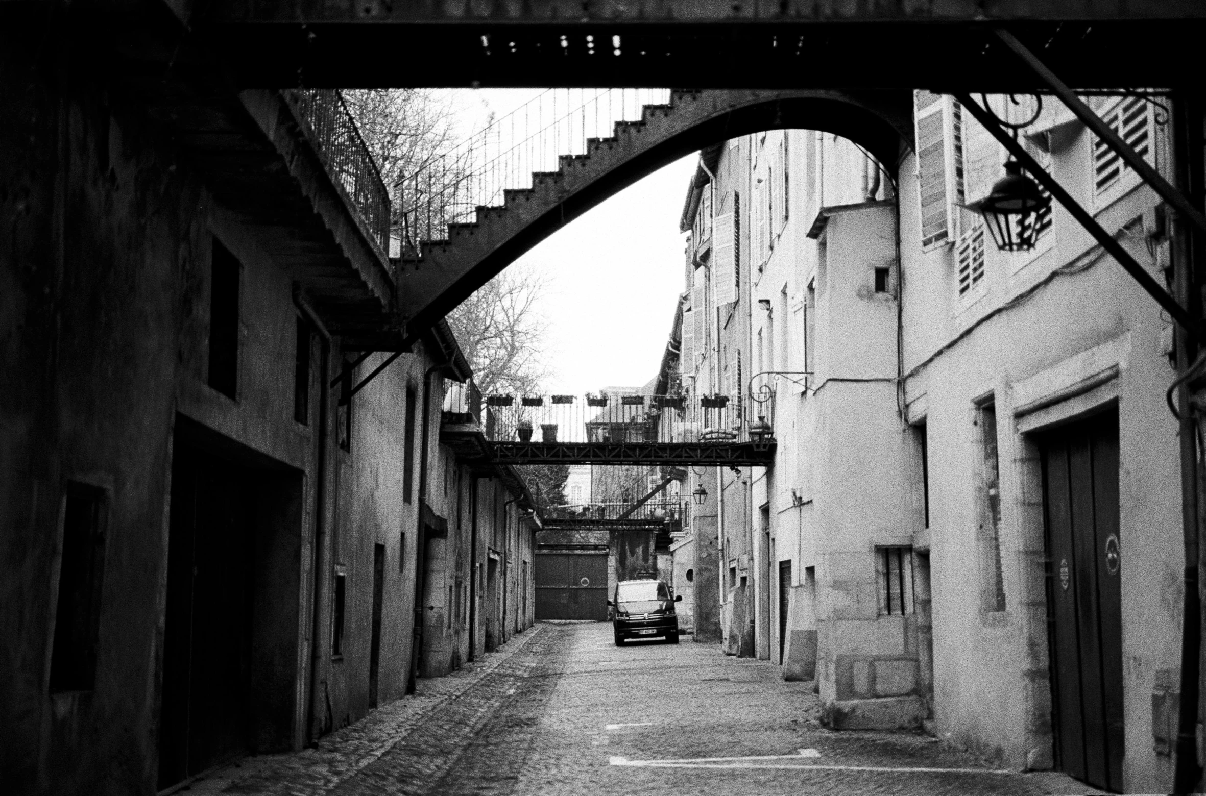 a small car driving down an empty alley