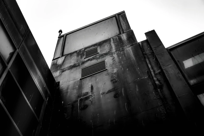 black and white pograph of windows on the side of an old building