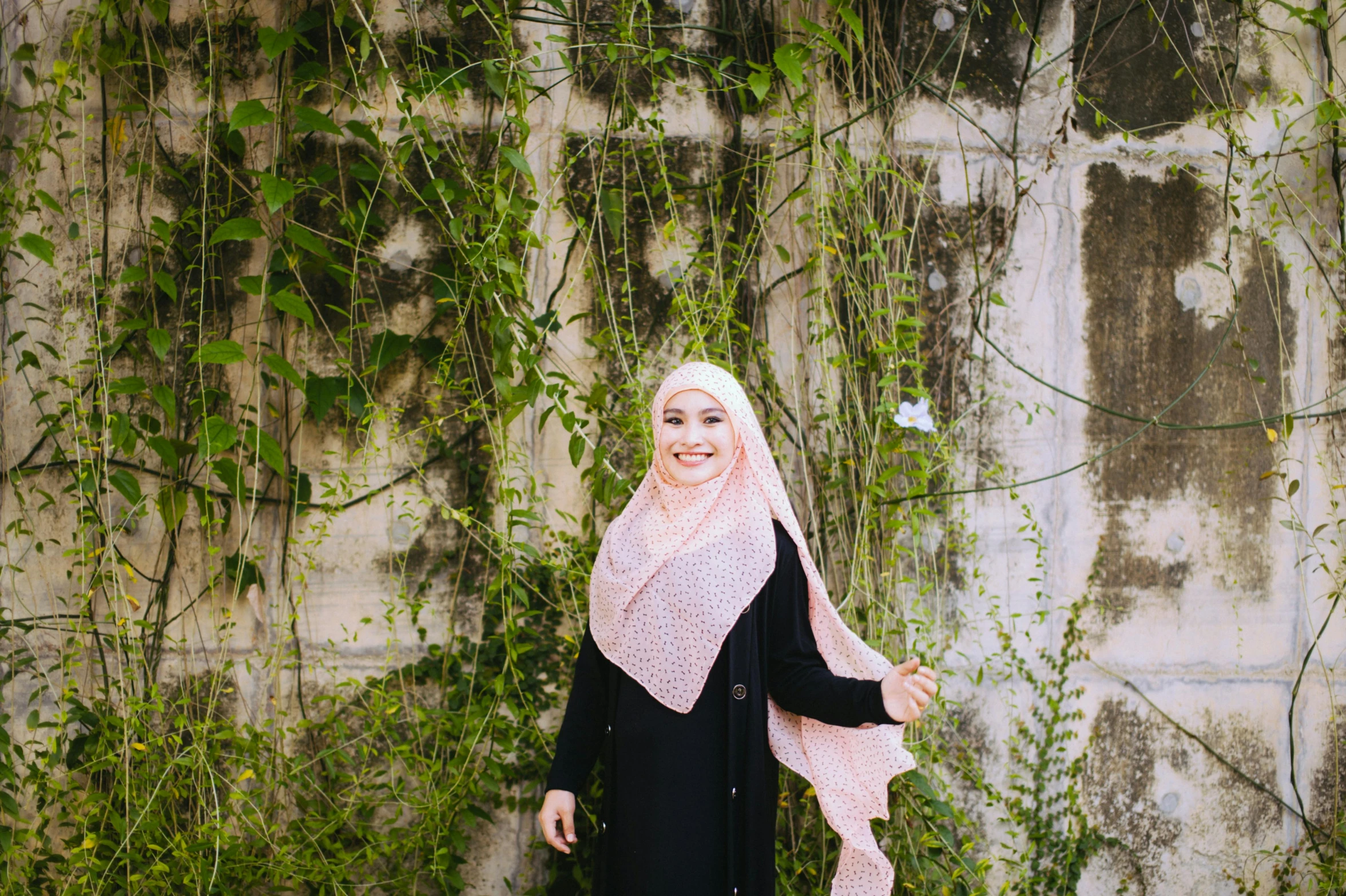 a beautiful woman standing in front of a wall