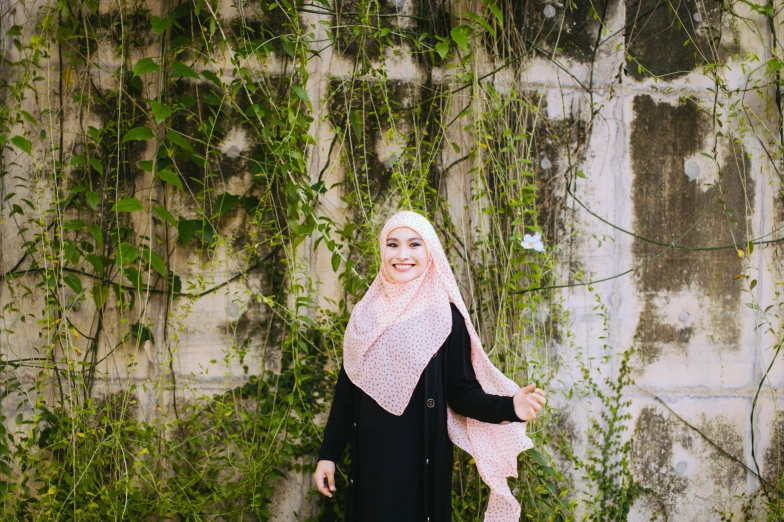 a beautiful woman standing in front of a wall